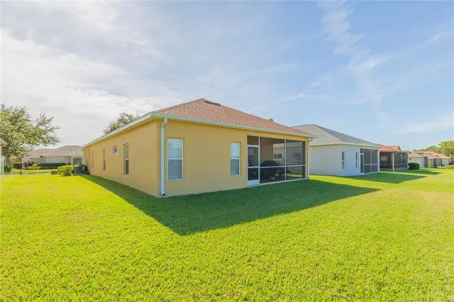 a view of an house with backyard space and balcony