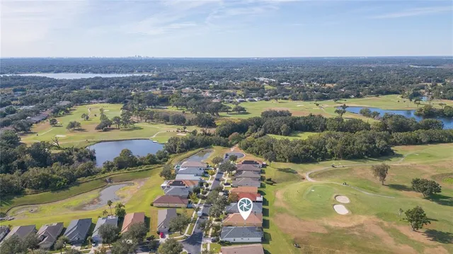an aerial view of house with yard swimming pool and ocean view