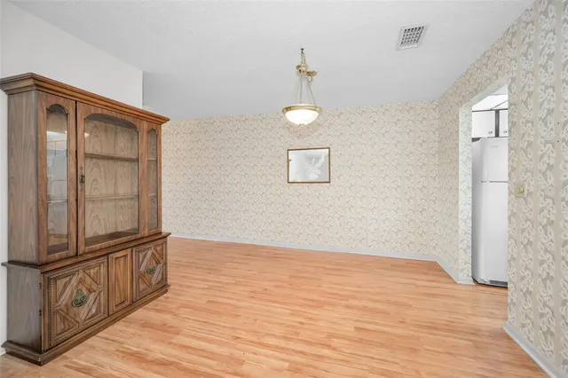 an empty room with closet and fan