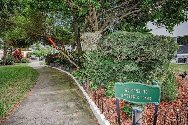 a view of a lake with a yard and large trees