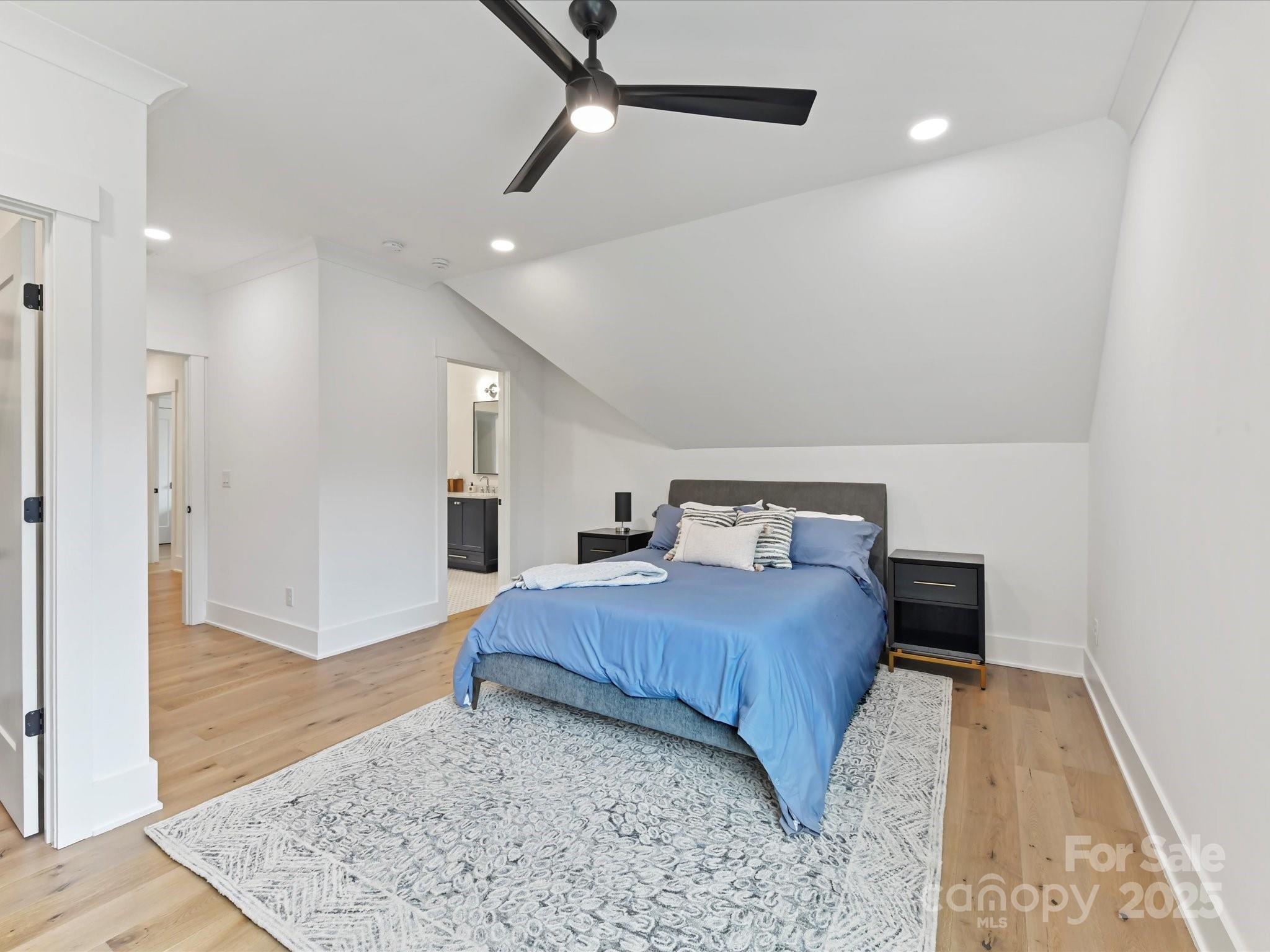 2954 Holbrook Road Fort Mill, SC 29715 - Photo 24 of 47 a spacious bedroom with a bed and wooden floor