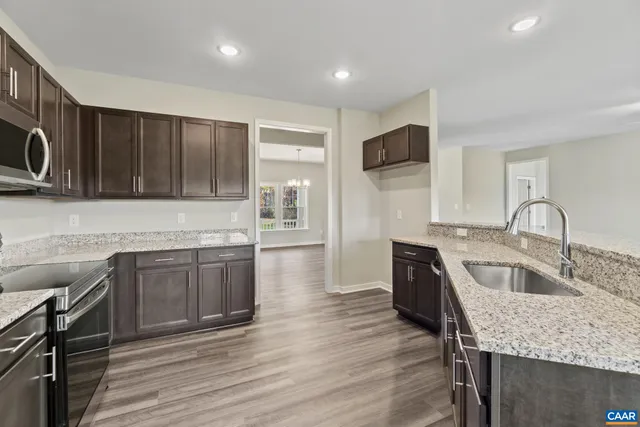 a view of a kitchen counter space and wooden floor