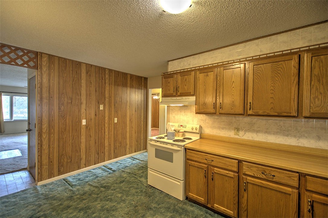 2273 North Fairview Avenue Decatur, IL 62526 - Photo 9 of 24 a kitchen with a stove a sink and a refrigerator