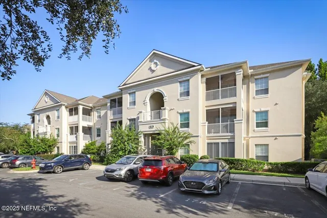 a view of a car parked in front of a brick house