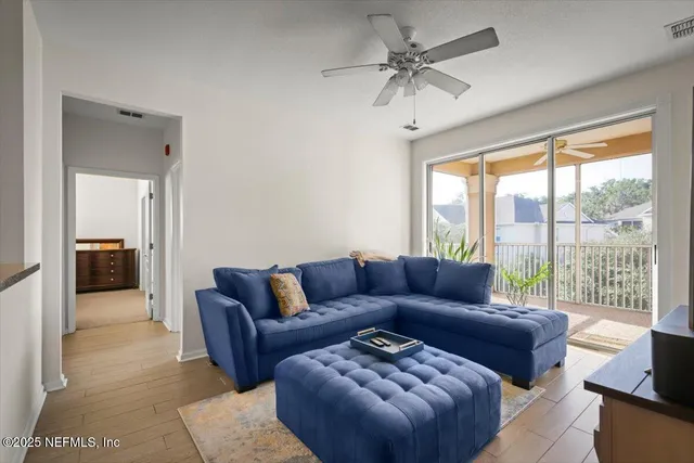 a living room with furniture ceiling fan and a rug