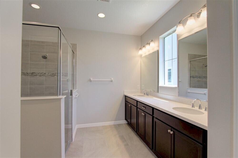 2508 Pangea Circle Melbourne, FL 32940 - Photo 14 of 34 a bathroom with a granite countertop sink mirror and double