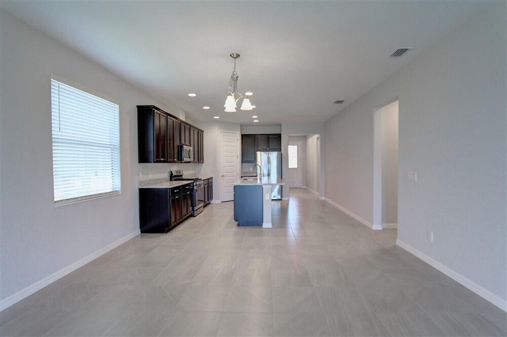 2508 Pangea Circle Melbourne, FL 32940 - Photo 18 of 34 a large kitchen with a sink and stainless steel appliances