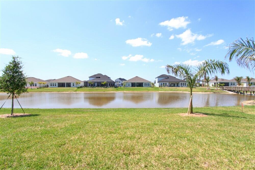 2508 Pangea Circle Melbourne, FL 32940 - Photo 32 of 34 a view of a lake with houses in the back