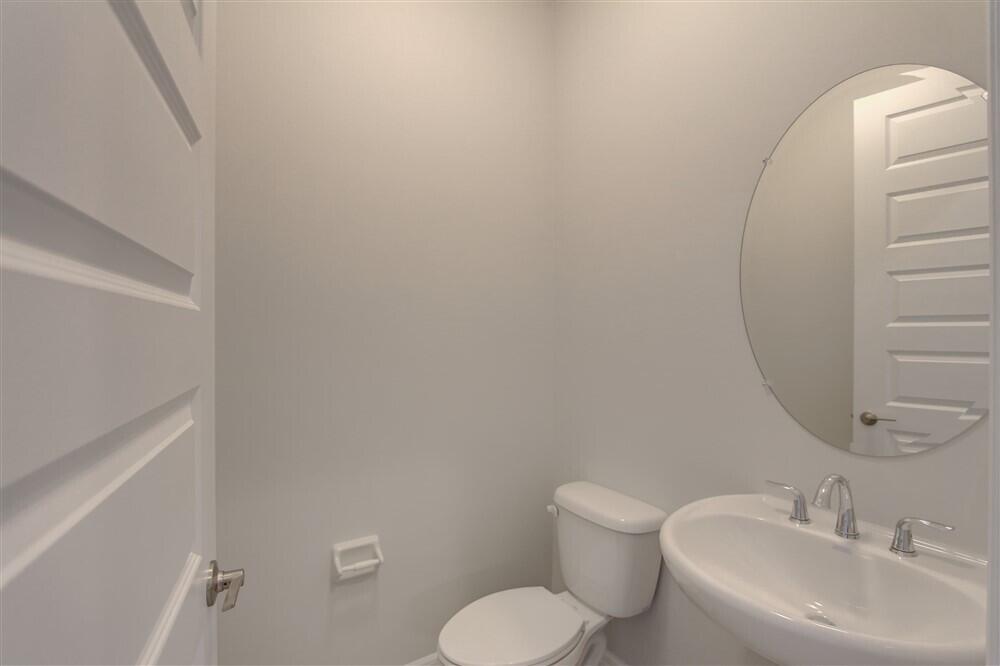 2508 Pangea Circle Melbourne, FL 32940 - Photo 8 of 34 a bathroom with a toilet sink and mirror