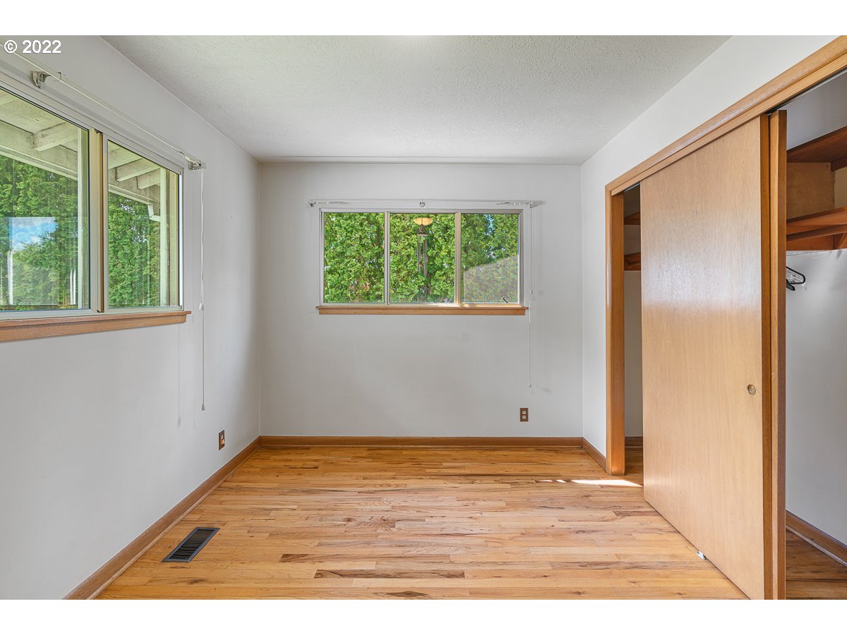 9020 Southwest Terwilliger Boulevard Portland, OR 97219 - Photo 12 of 31 a view of an empty room with wooden floor and windows