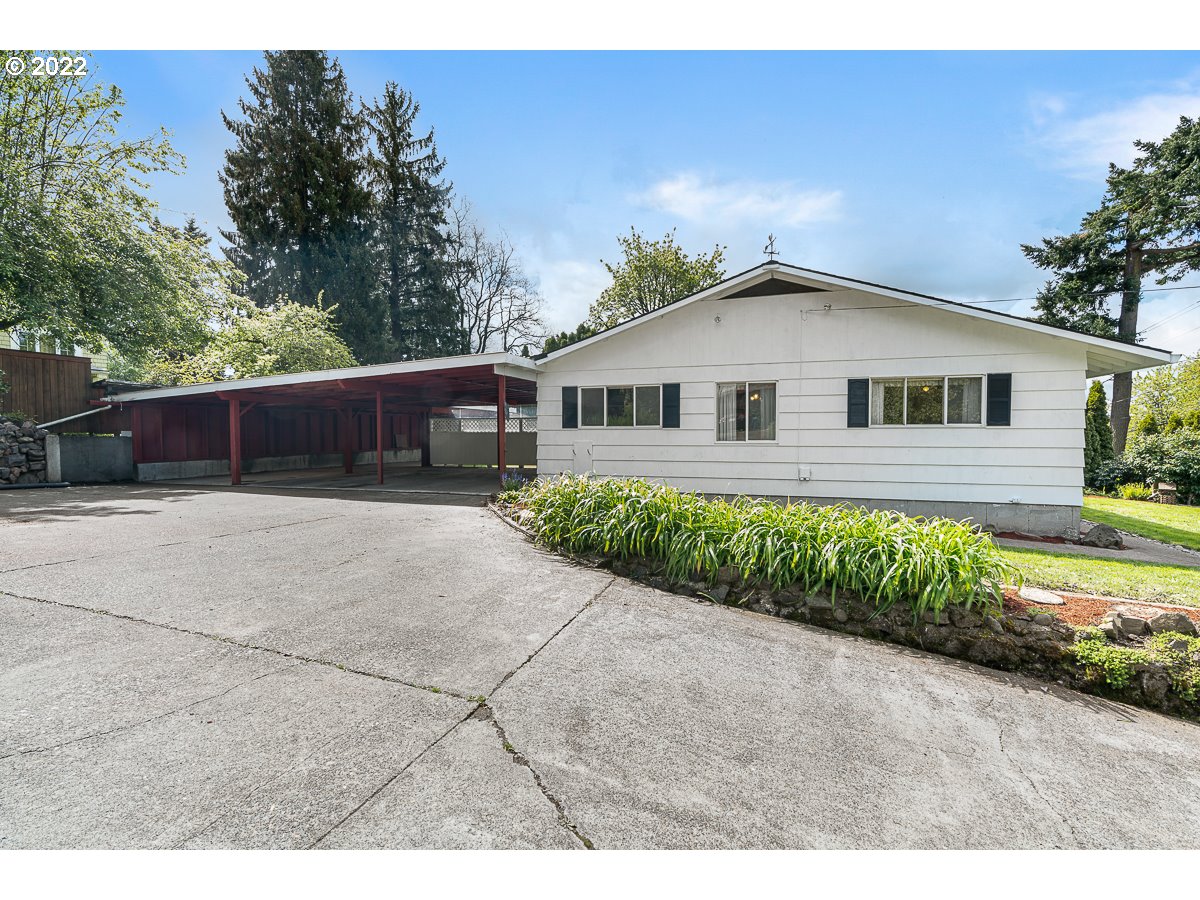 9020 Southwest Terwilliger Boulevard Portland, OR 97219 - Photo 2 of 31 a front view of a house with a yard