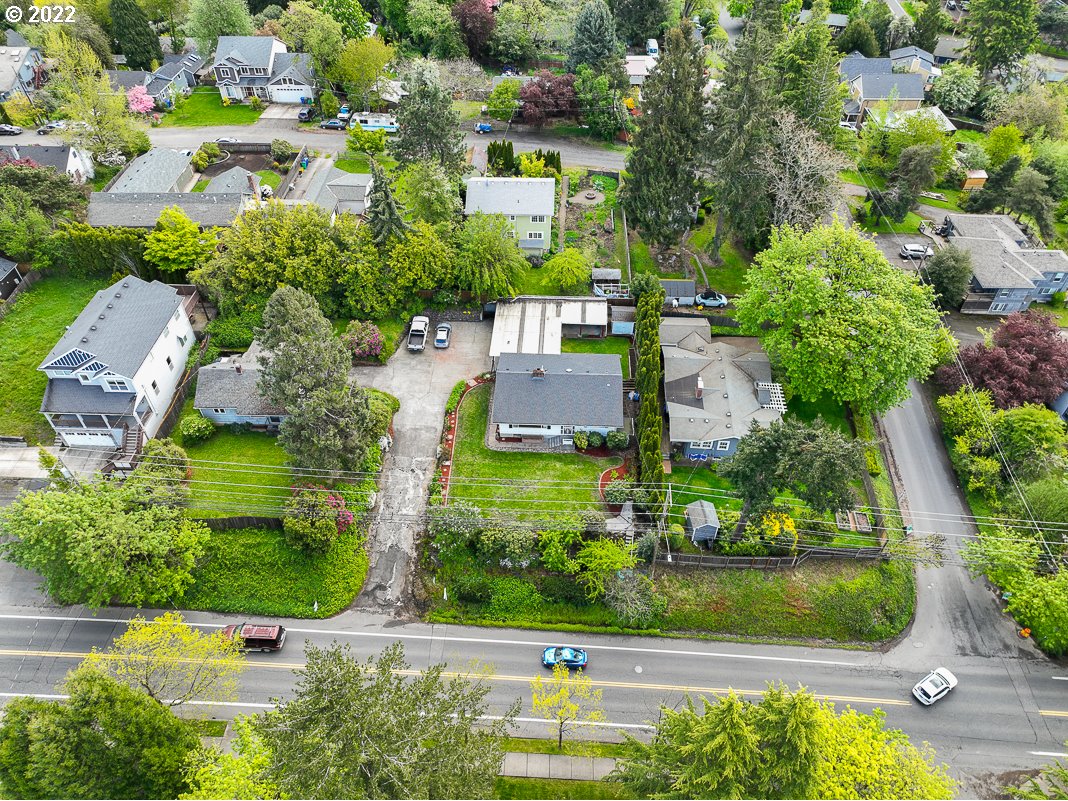 9020 Southwest Terwilliger Boulevard Portland, OR 97219 - Photo 26 of 31 an aerial view of a house with a yard and lake view