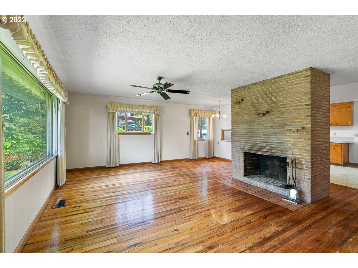 9020 Southwest Terwilliger Boulevard Portland, OR 97219 - Photo 5 of 31 a view of an empty room with a window and fireplace