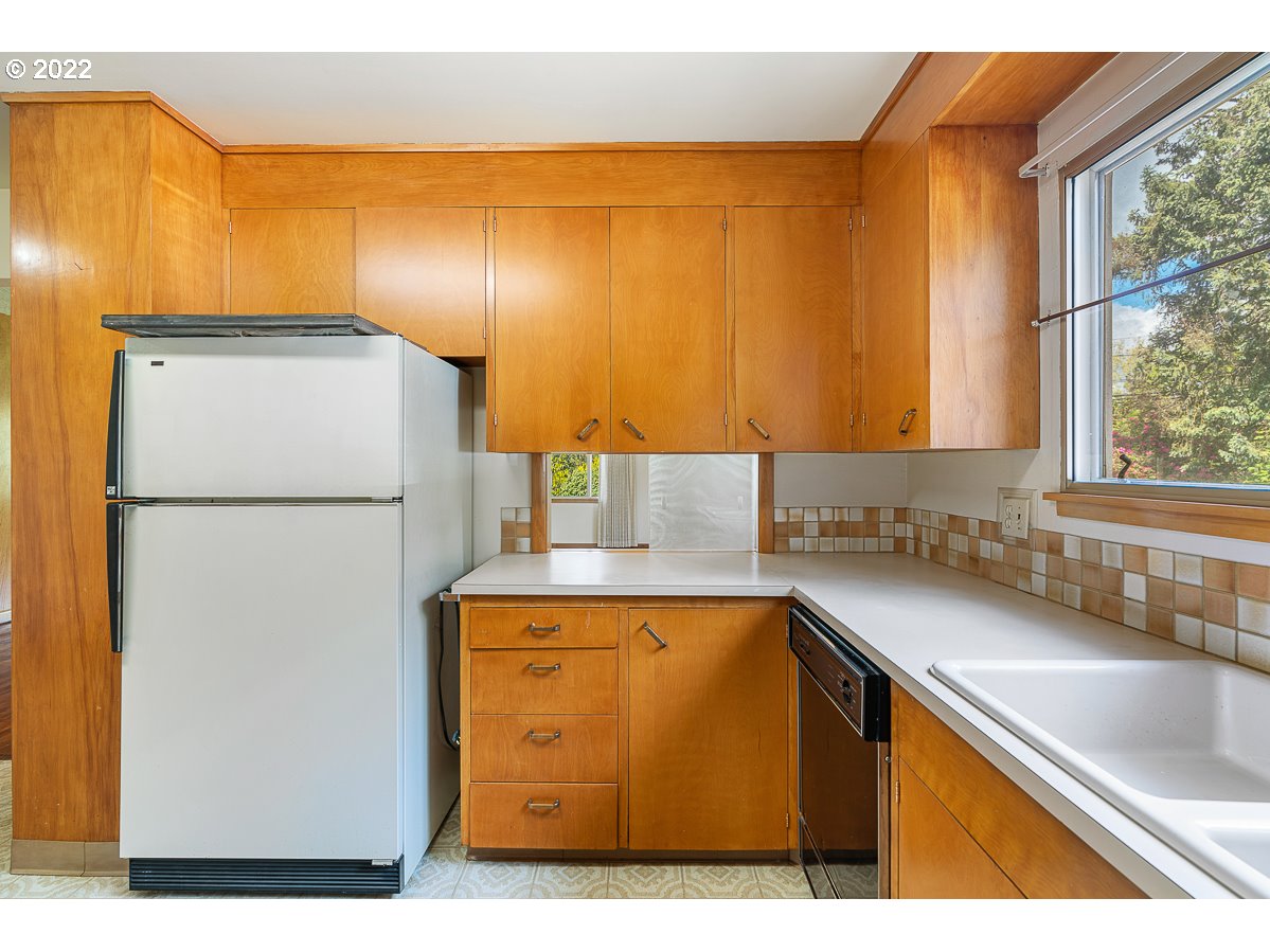 9020 Southwest Terwilliger Boulevard Portland, OR 97219 - Photo 9 of 31 a kitchen with a sink a refrigerator and a window
