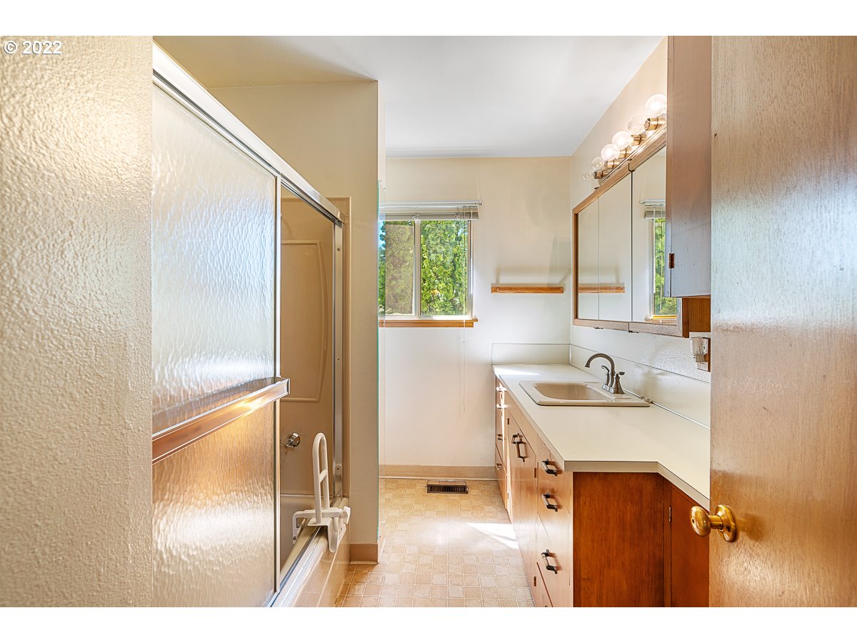 9020 Southwest Terwilliger Boulevard Portland, OR 97219 - Photo 10 of 31 a bathroom with a sink and a mirror