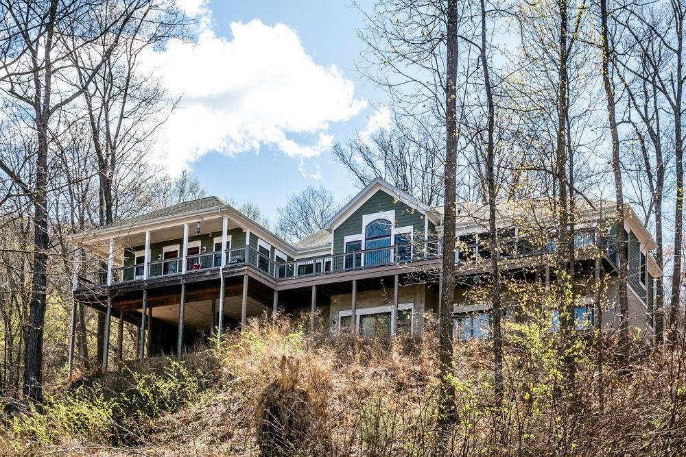 a view of a house with yard and sitting area