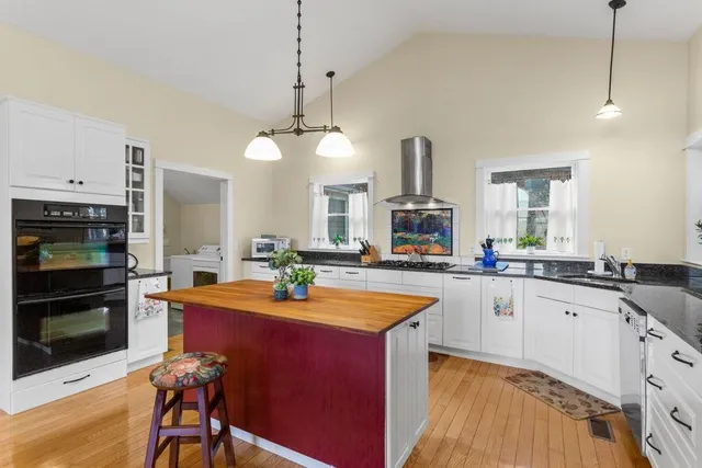 a kitchen with stainless steel appliances a sink stove and refrigerator