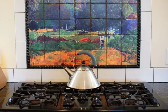 a kitchen with a sink and a stove next to a window