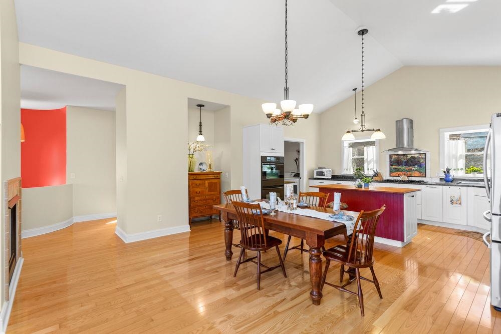 9586 Brunk Spring Lane Broadway, VA 22815 - Photo 14 of 58 a view of a dining room and livingroom with furniture wooden floor a rug a chandelier and a view
