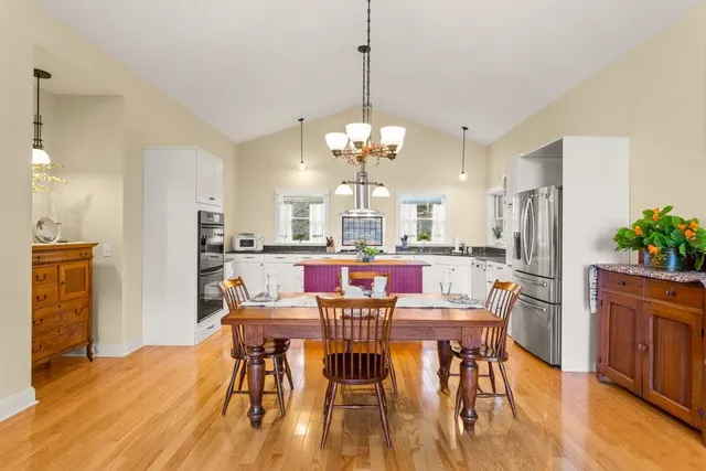 a view of a dining room with furniture and wooden floor