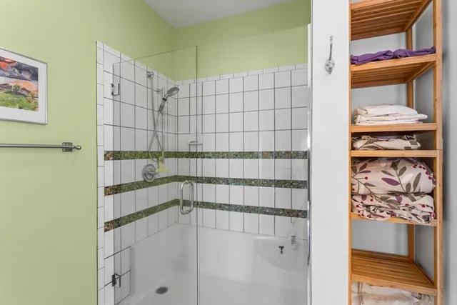 a bathroom with a tub sink and mirror