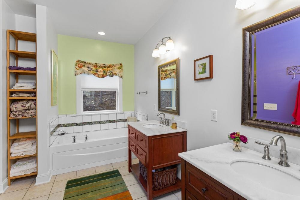 9586 Brunk Spring Lane Broadway, VA 22815 - Photo 30 of 58 a bathroom with a tub sink and mirror