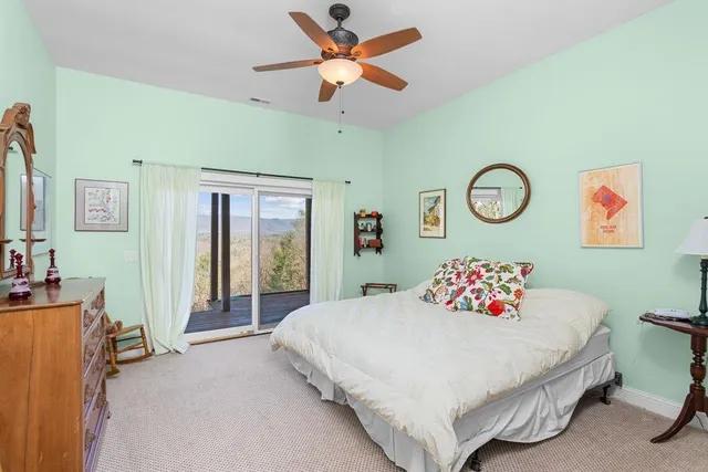 a view of roof deck with wooden floor and fence