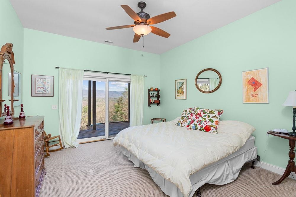 9586 Brunk Spring Lane Broadway, VA 22815 - Photo 38 of 58 a bedroom with a bed and a chandelier