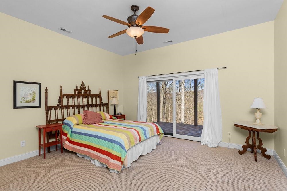 9586 Brunk Spring Lane Broadway, VA 22815 - Photo 39 of 58 a bedroom with a bed and a chandelier