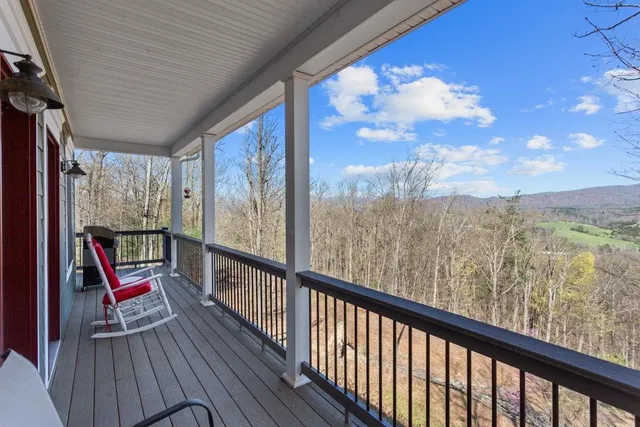 a view of a house with backyard and deck