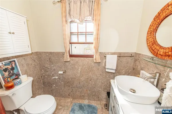 a bathroom with a toilet a sink and a mirror