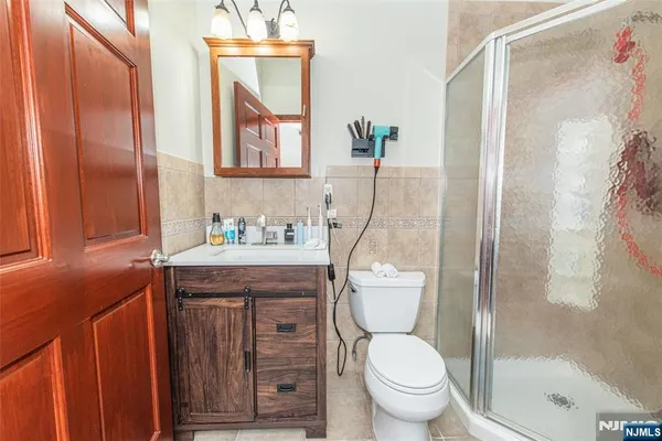 a bathroom with a granite countertop toilet a sink and a mirror