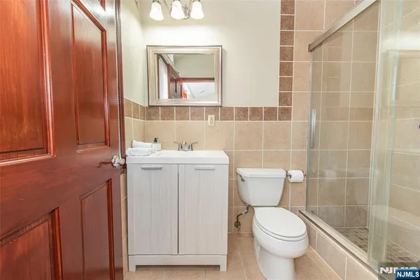 a bathroom with a toilet sink and mirror