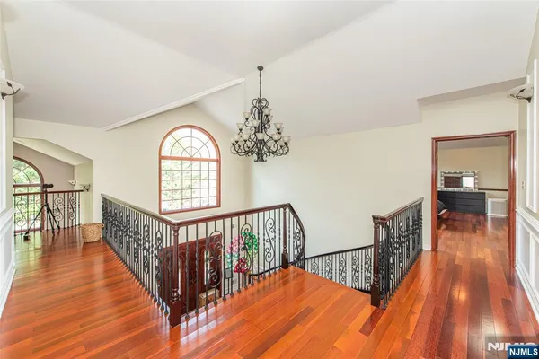 a view of hallway with wooden floor