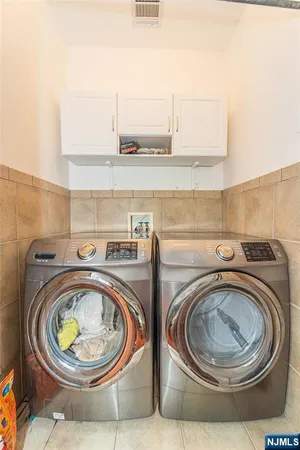 a utility room with sink dryer and washer