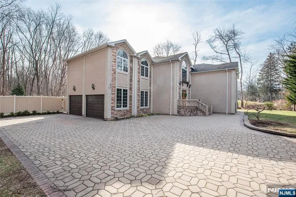 a backyard of a house with barbeque oven and brick wall