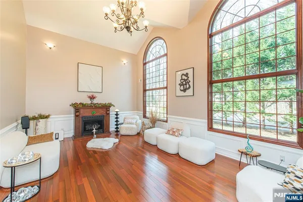 a living room with furniture a fireplace and a large window