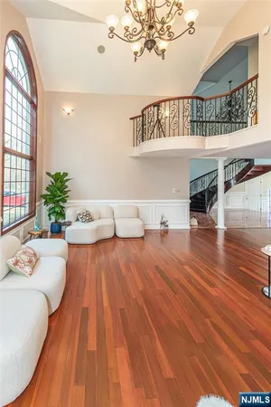 a living room with furniture and a chandelier