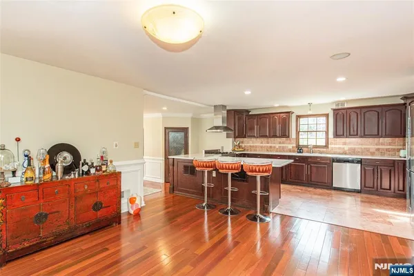 a large kitchen with a table and chairs in it