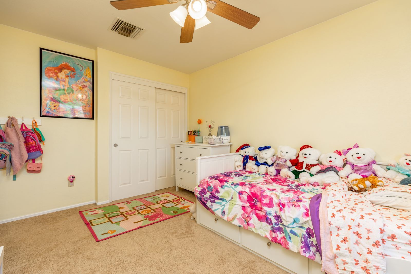 1047 Carolyn Street Ridgecrest, CA 93555 - Photo 23 of 35 a bedroom with baby bed toys and paintings on the wall