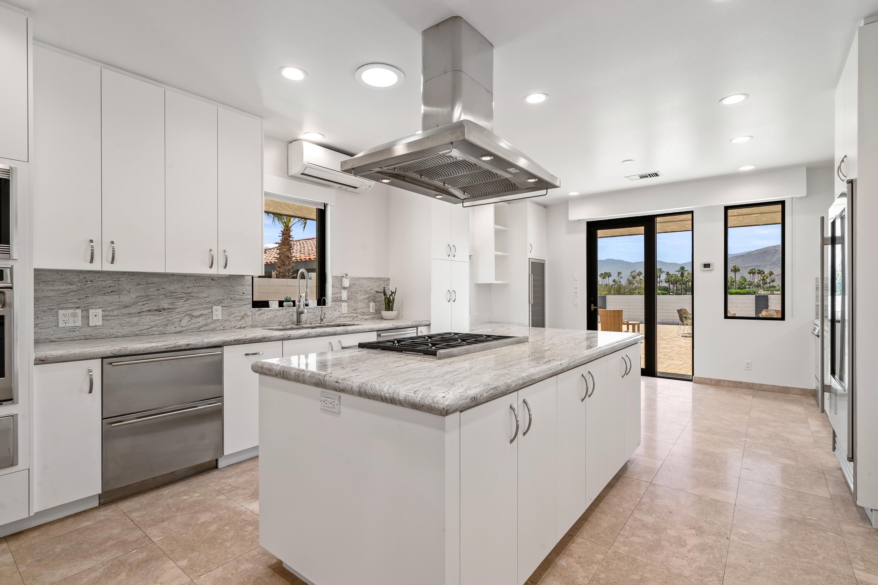 401 Iris Lane Rancho Mirage, CA 92270 - Photo 21 of 87 a kitchen with stainless steel appliances granite countertop a sink and a stove