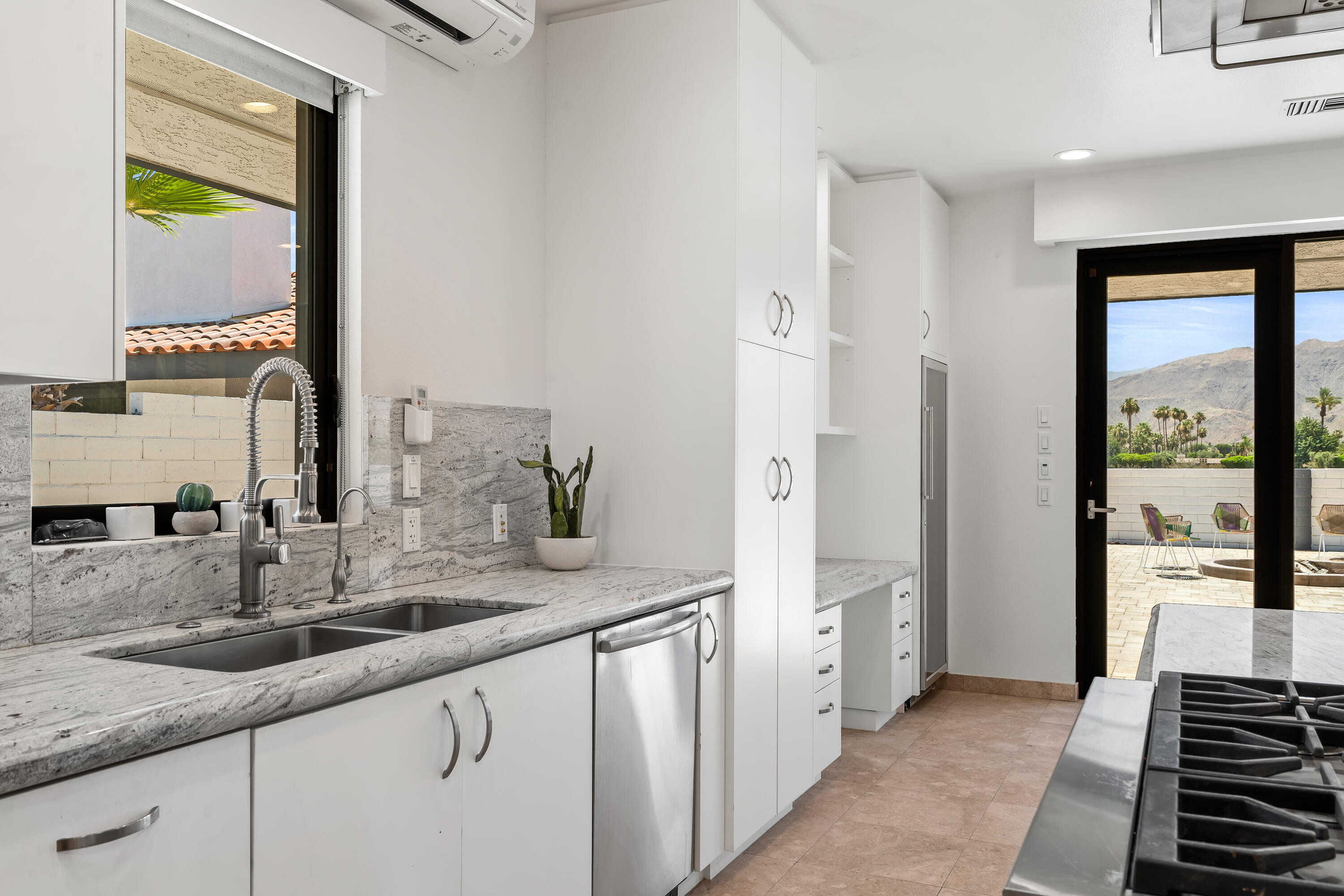 401 Iris Lane Rancho Mirage, CA 92270 - Photo 23 of 87 a bathroom with a double vanity sink and a mirror