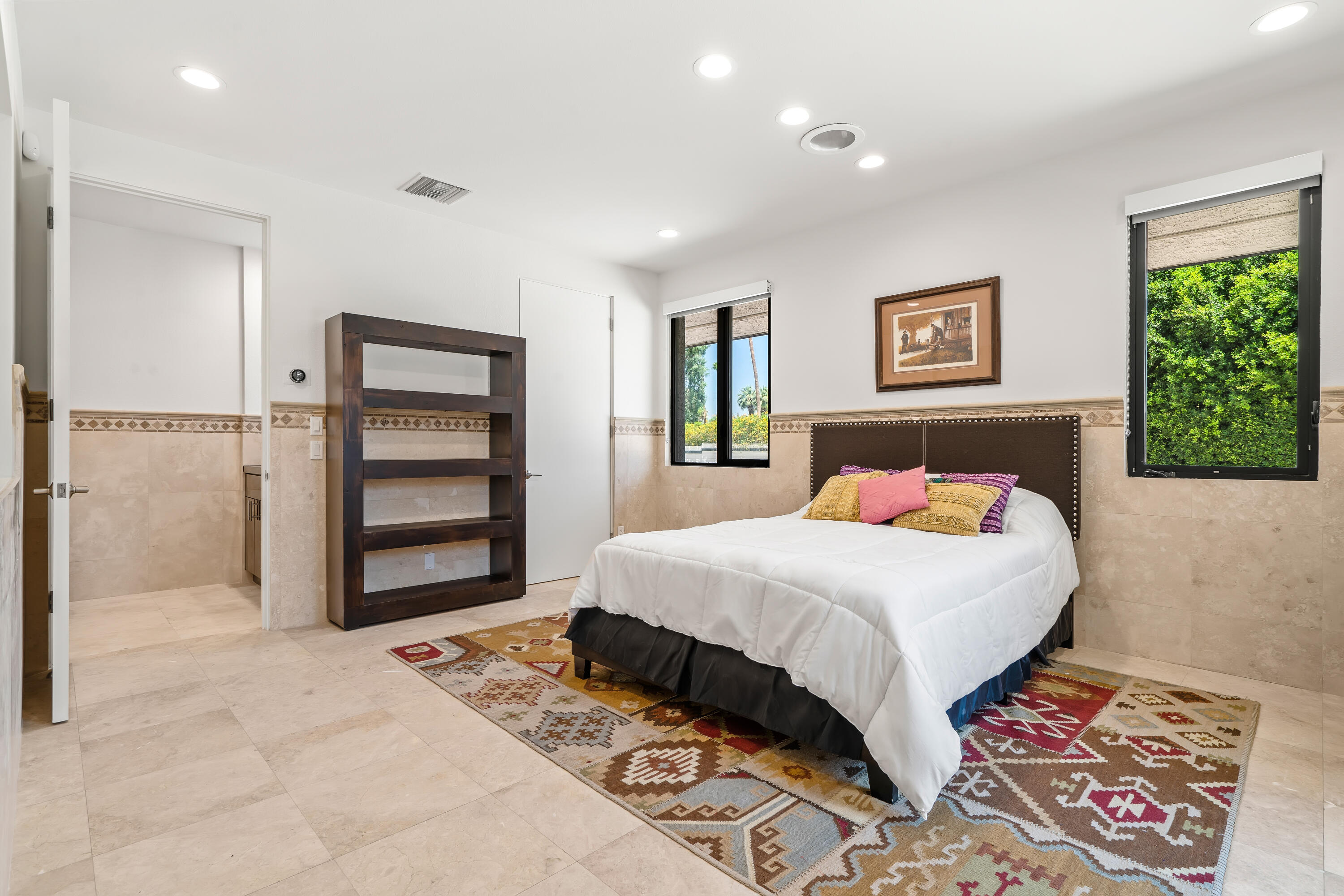 401 Iris Lane Rancho Mirage, CA 92270 - Photo 30 of 87 a bedroom with a bed and a painting