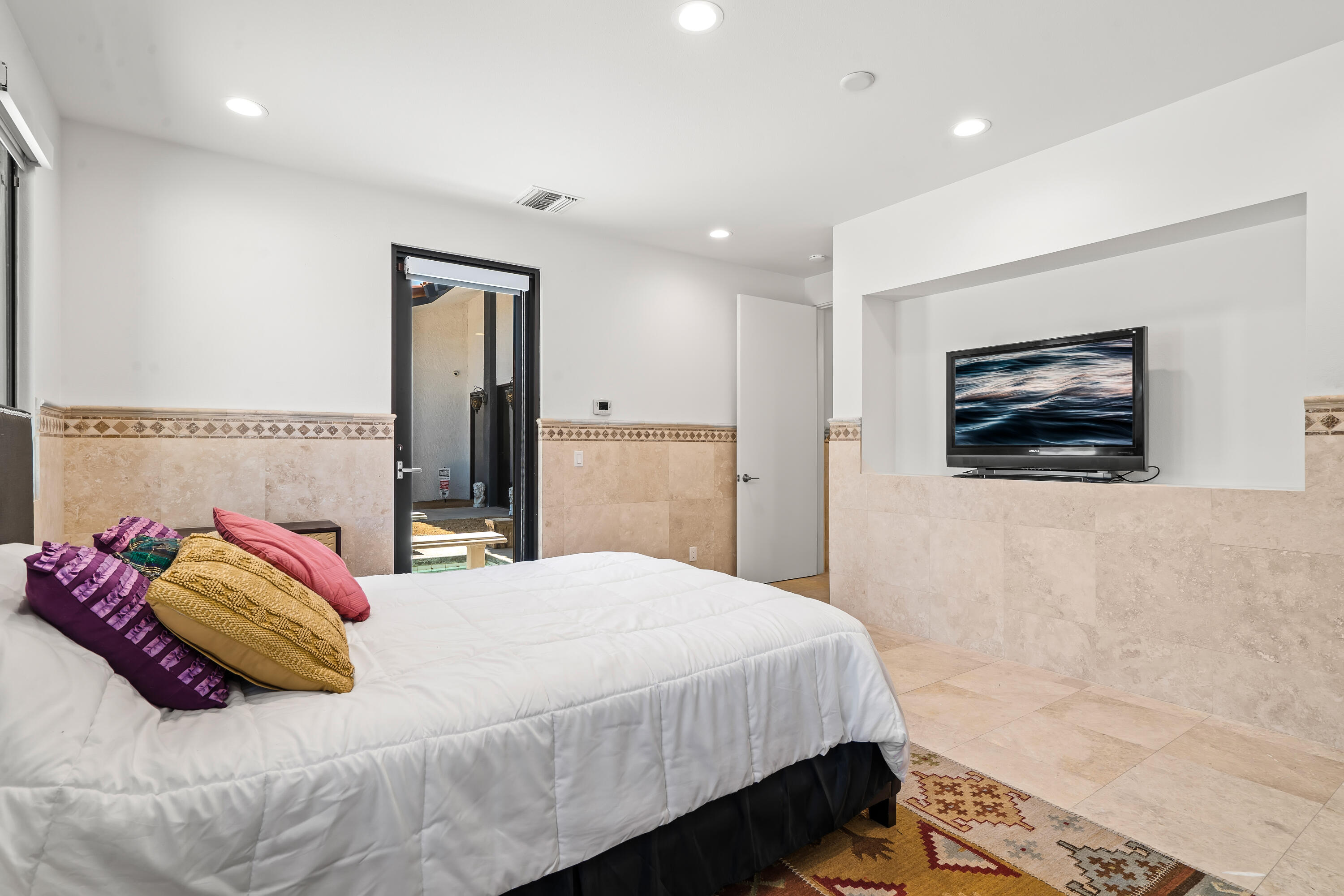 401 Iris Lane Rancho Mirage, CA 92270 - Photo 31 of 87 a bedroom with a large bed and a couch