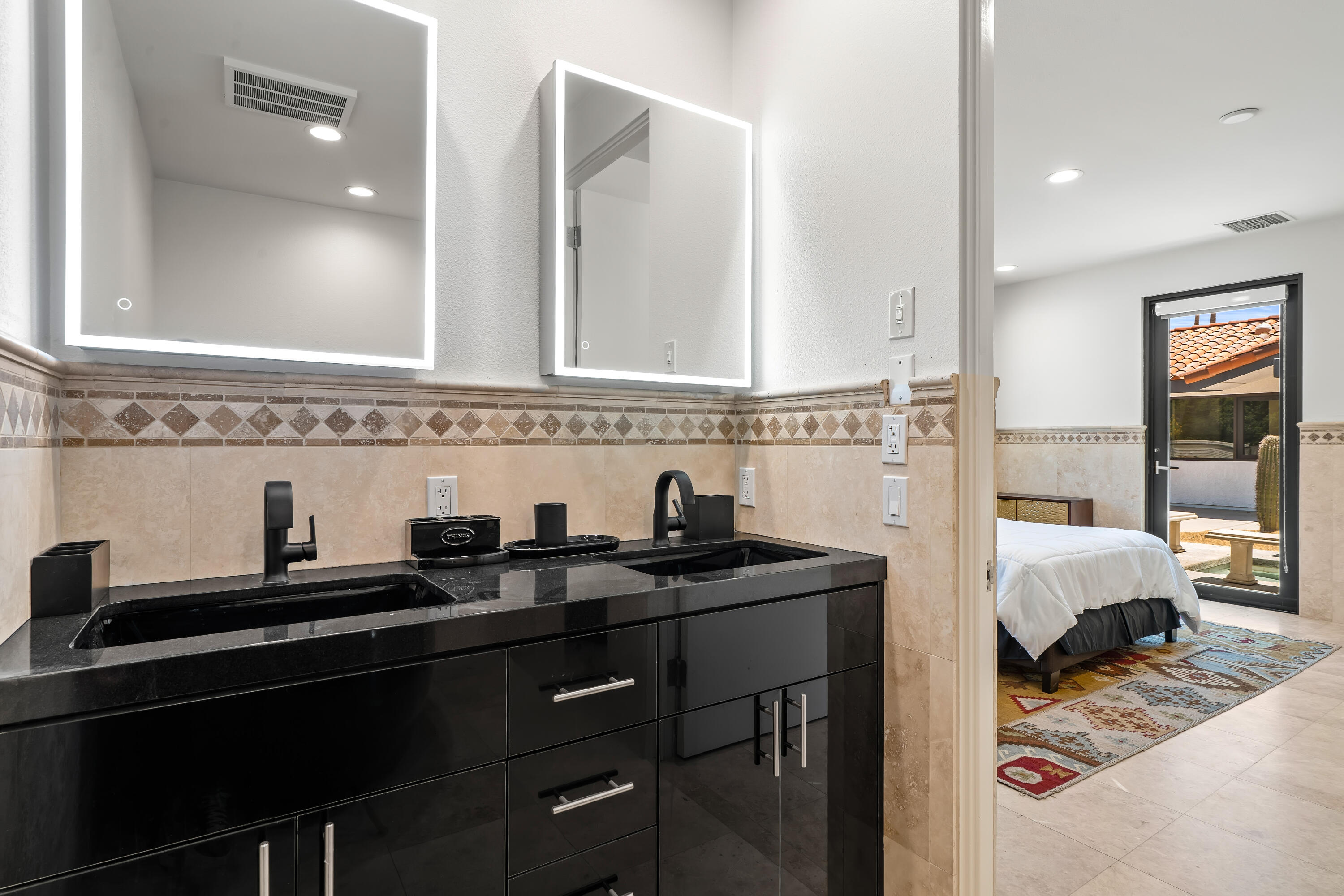 401 Iris Lane Rancho Mirage, CA 92270 - Photo 32 of 87 a en suite bathroom with a sink and a mirror
