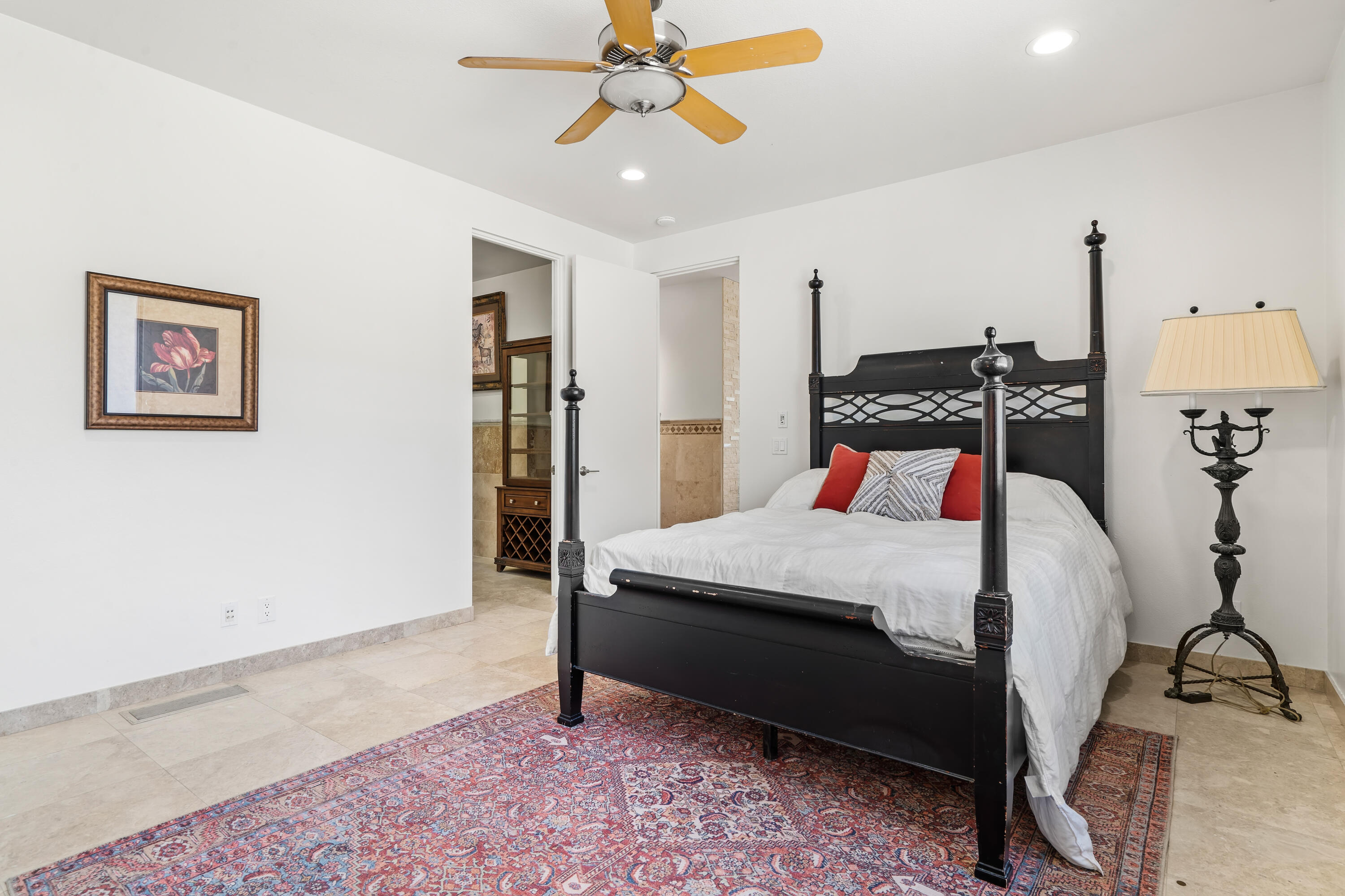 401 Iris Lane Rancho Mirage, CA 92270 - Photo 45 of 87 a bedroom with a bed and a chandelier