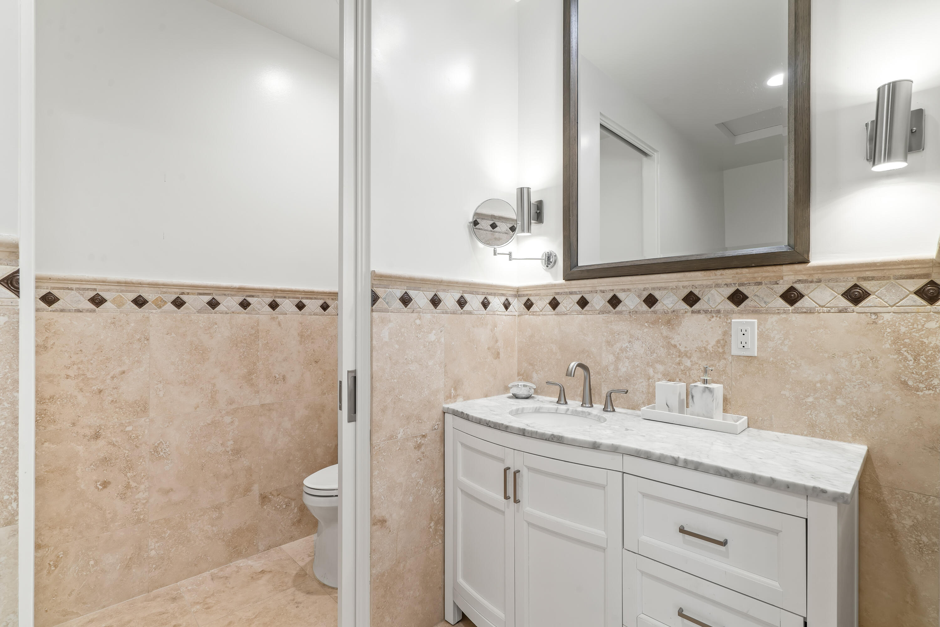 401 Iris Lane Rancho Mirage, CA 92270 - Photo 52 of 87 a bathroom with a granite countertop sink a toilet and a mirror