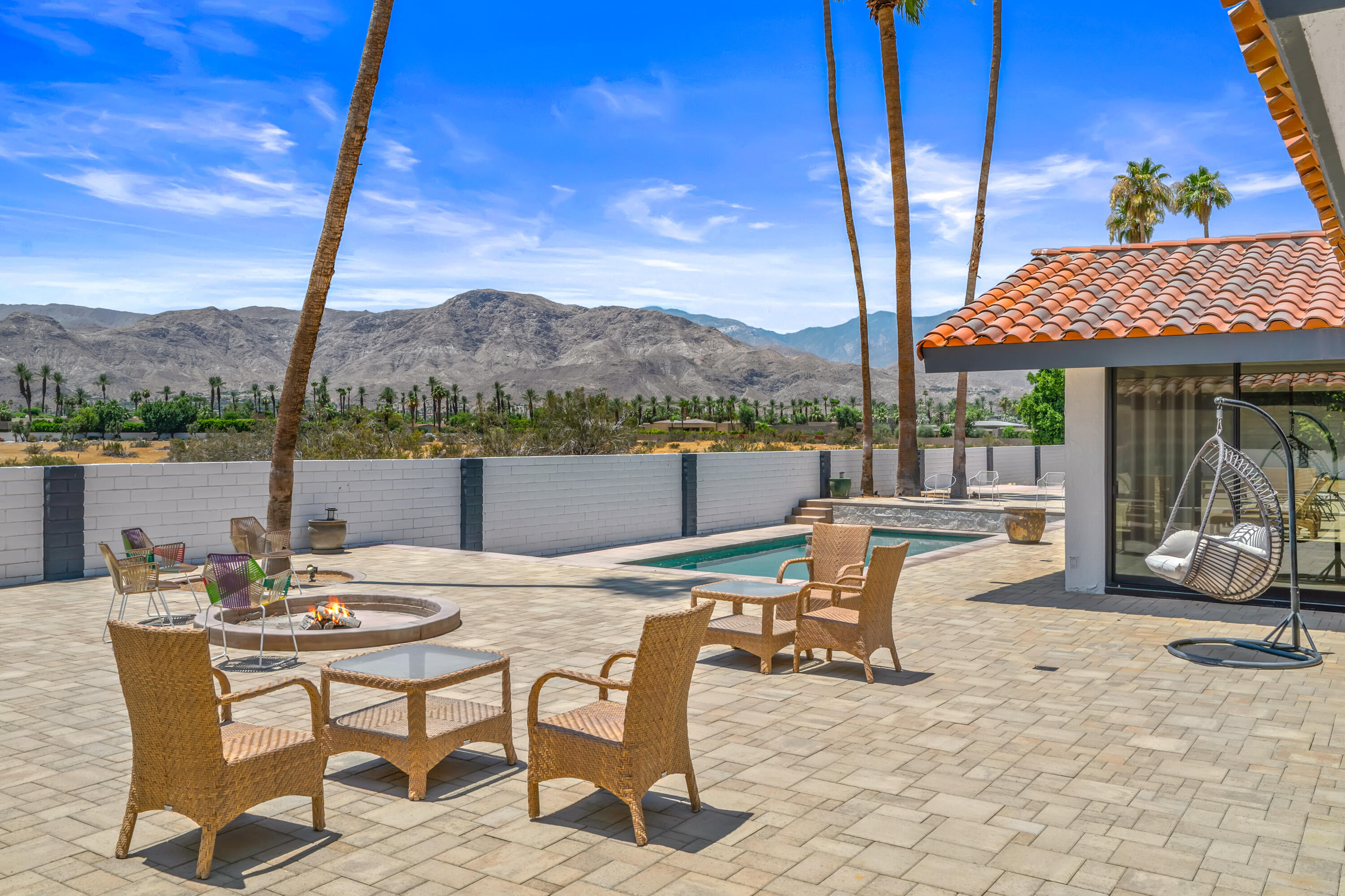 401 Iris Lane Rancho Mirage, CA 92270 - Photo 56 of 87 a view of a patio with a table chairs and a table