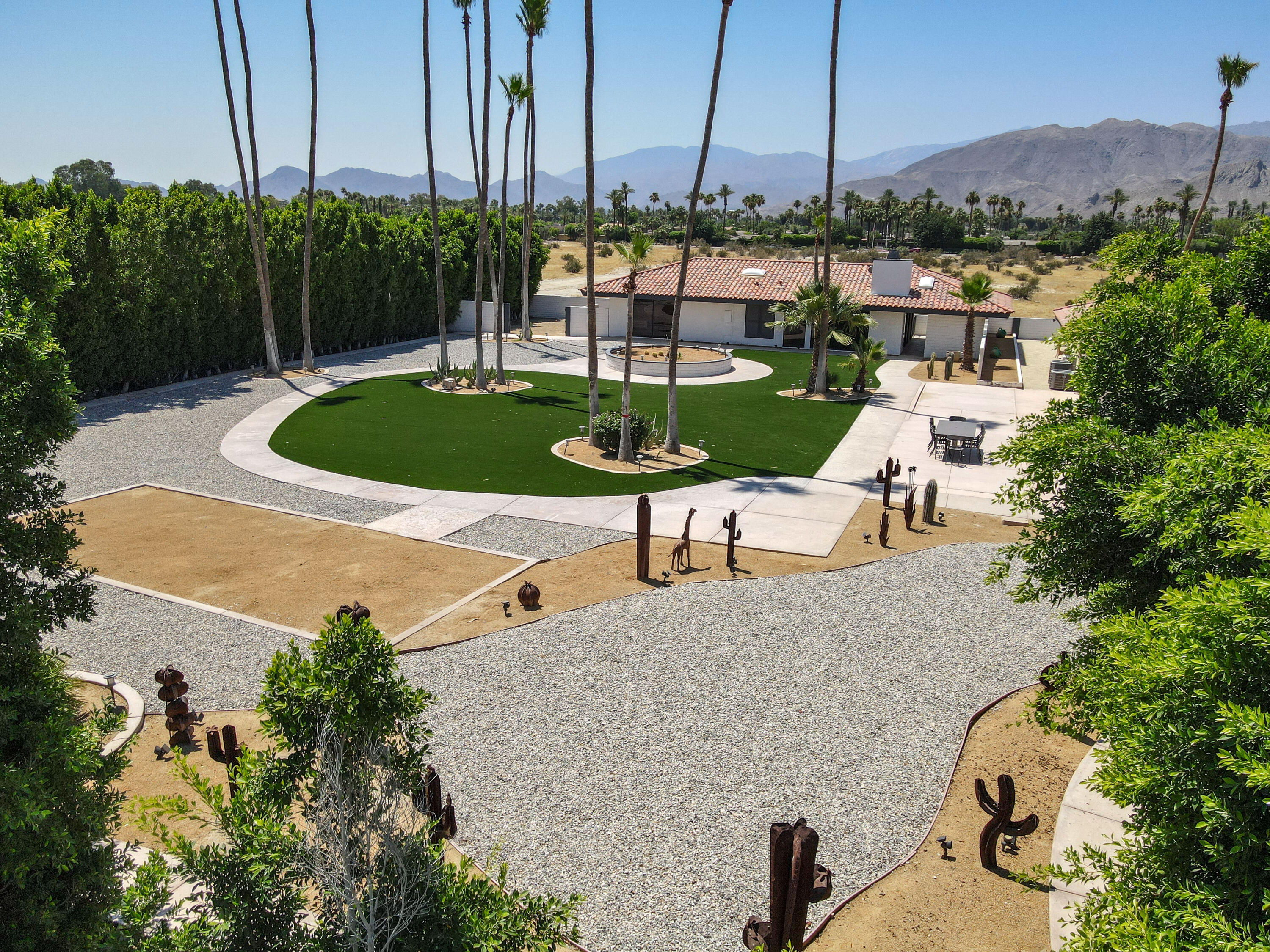 401 Iris Lane Rancho Mirage, CA 92270 - Photo 64 of 87 a view of a patio with a table chairs and a swimming pool