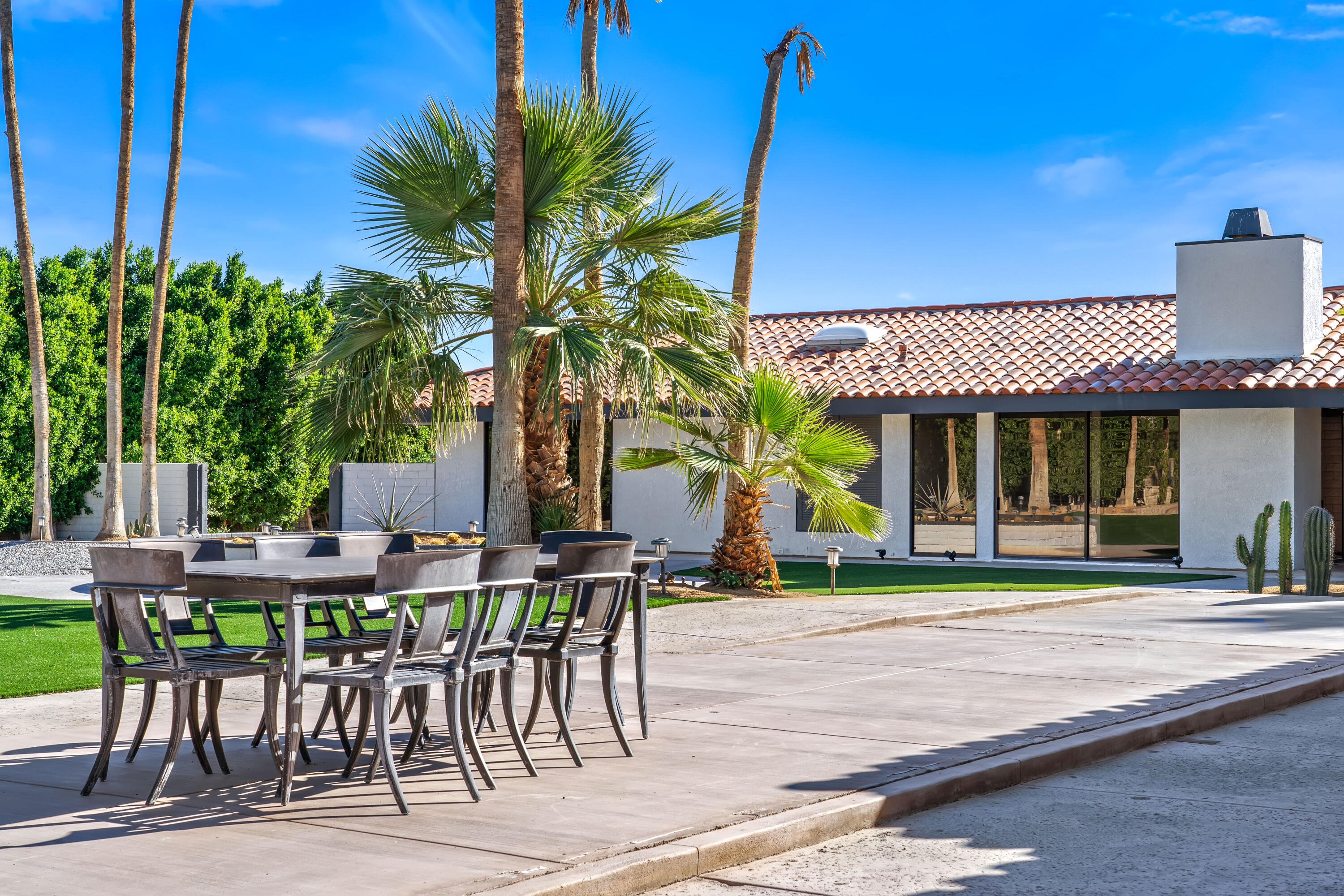401 Iris Lane Rancho Mirage, CA 92270 - Photo 68 of 87 a view of a cafe with a table and chairs under an umbrella